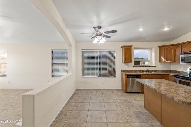 kitchen with light tile patterned floors, stainless steel appliances, ceiling fan, and sink