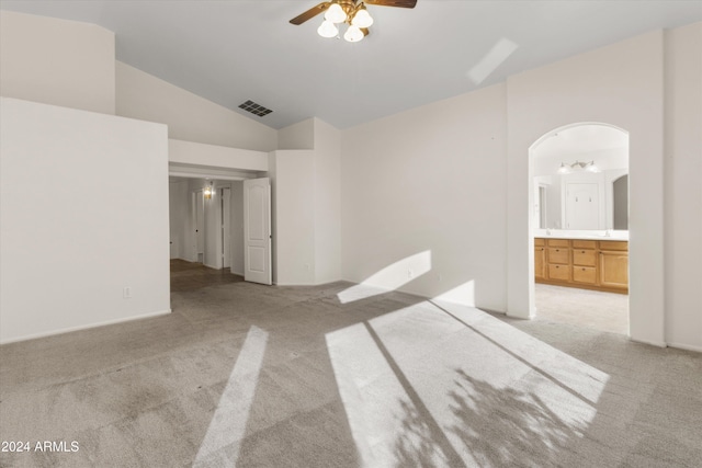 carpeted empty room featuring vaulted ceiling and ceiling fan