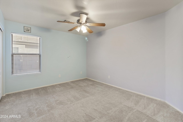 spare room with light carpet and ceiling fan