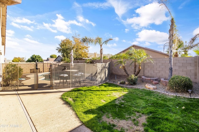 view of yard featuring a swimming pool and a patio