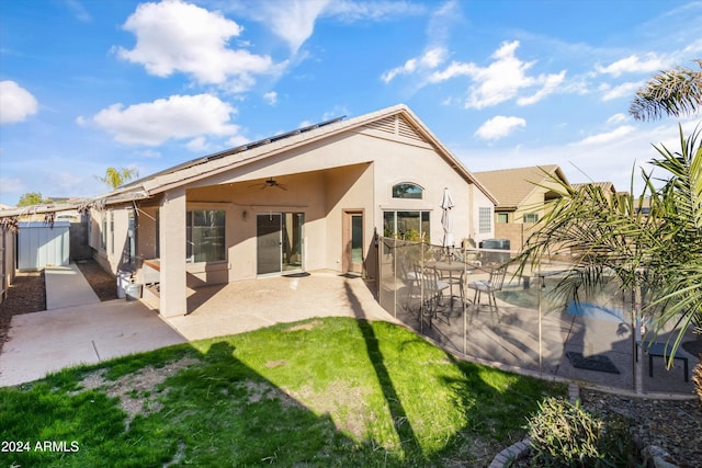 rear view of house with ceiling fan and a patio area