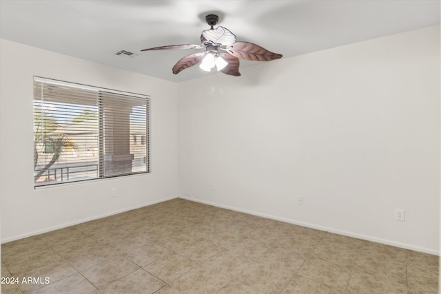 unfurnished room with ceiling fan and light tile patterned floors