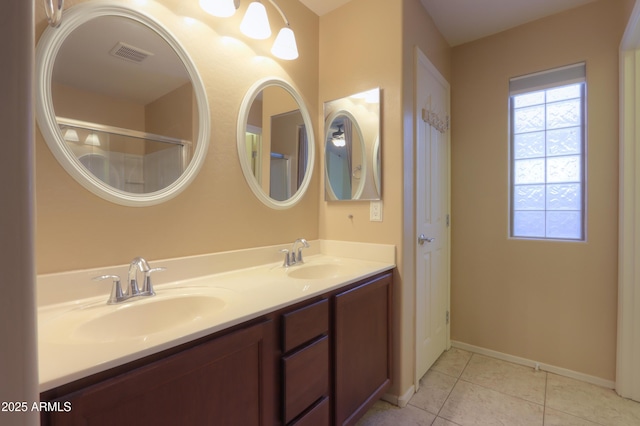 bathroom with tile patterned floors and vanity