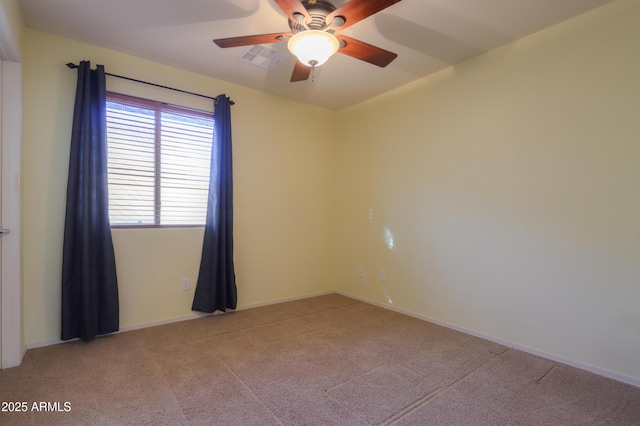 carpeted spare room featuring ceiling fan