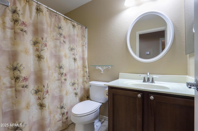 bathroom with toilet and vanity