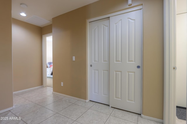 interior space featuring a closet and light tile patterned flooring