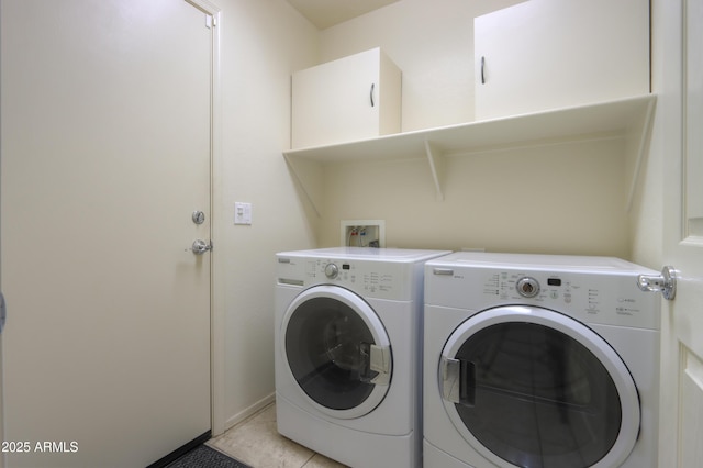 laundry room with washing machine and clothes dryer and light tile patterned floors