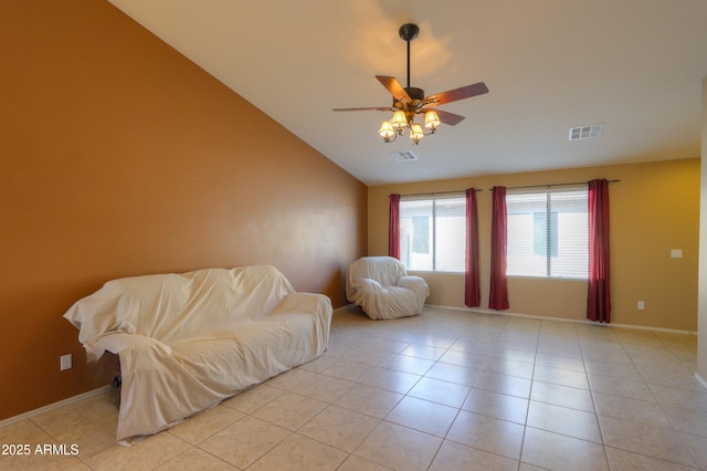 living area with light tile patterned flooring, ceiling fan, and vaulted ceiling