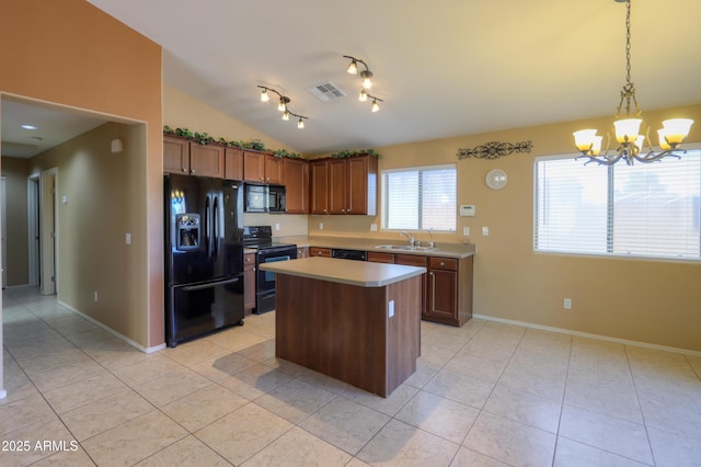 kitchen featuring vaulted ceiling, pendant lighting, a kitchen island, a chandelier, and black appliances