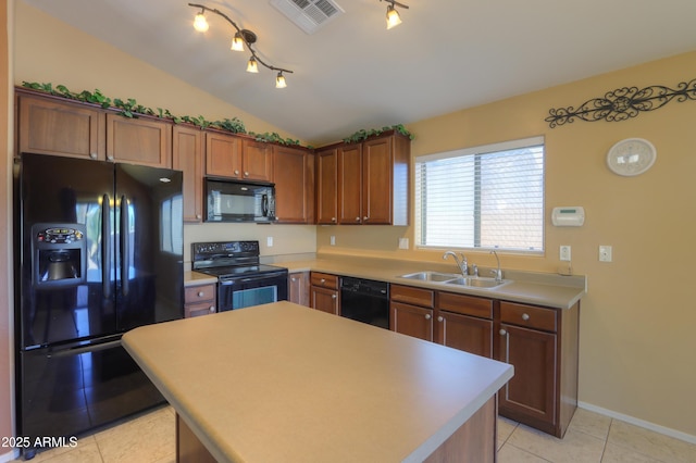 kitchen with vaulted ceiling, black appliances, a kitchen island, light tile patterned flooring, and sink