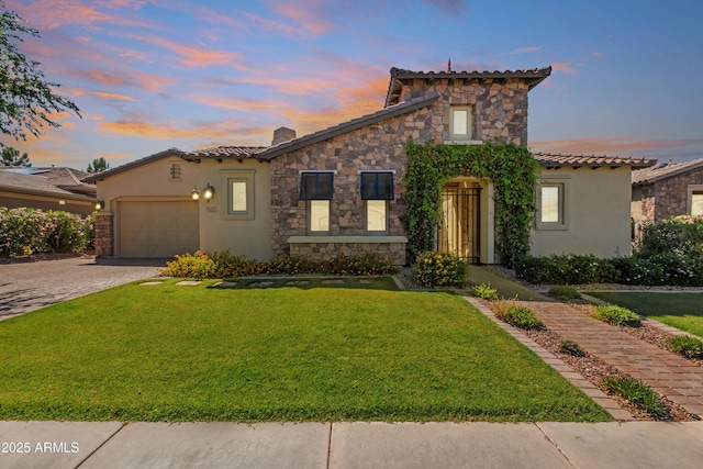 5226 S Fairchild Ln, Chandler, AZ 85249 - mediterranean / spanish house featuring stucco siding, an attached garage, and a lawn
