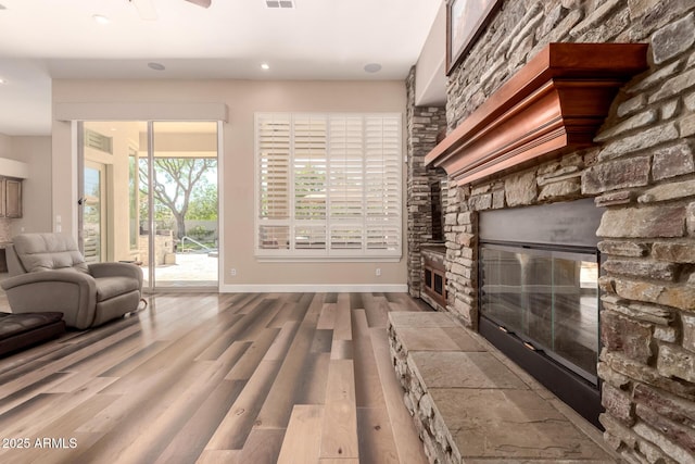 5226 S Fairchild Ln, Chandler, AZ 85249 - living room featuring a fireplace, recessed lighting, wood finished floors, and baseboards