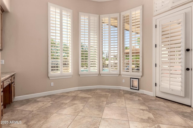 5226 S Fairchild Ln, Chandler, AZ 85249 - unfurnished dining area featuring baseboards and light tile patterned floors