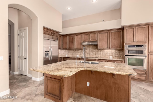 5226 S Fairchild Ln, Chandler, AZ 85249 - kitchen featuring stainless steel appliances, tasteful backsplash, light stone counters, and recessed lighting