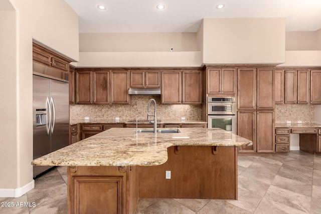 5226 S Fairchild Ln, Chandler, AZ 85249 - kitchen featuring stainless steel appliances, a sink, a breakfast bar, light stone countertops, and decorative backsplash