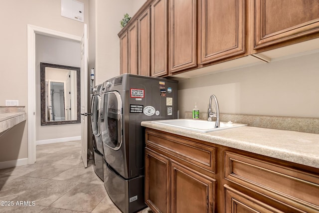 5226 S Fairchild Ln, Chandler, AZ 85249 - laundry room with independent washer and dryer, cabinet space, light tile patterned flooring, and baseboards