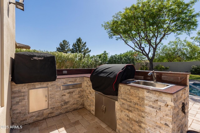 5226 S Fairchild Ln, Chandler, AZ 85249 - view of patio featuring a sink, area for grilling, a grill, and fence