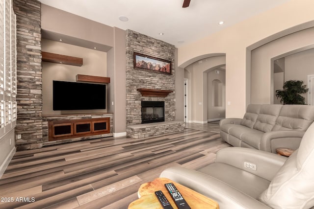 5226 S Fairchild Ln, Chandler, AZ 85249 - living room with wood finished floors, a fireplace, recessed lighting, baseboards, and arched walkways