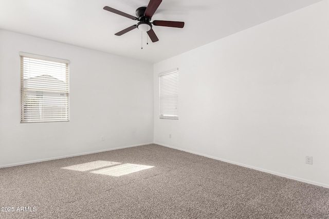 empty room featuring a ceiling fan, baseboards, and carpet flooring