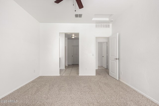 unfurnished bedroom with light carpet, baseboards, visible vents, and attic access