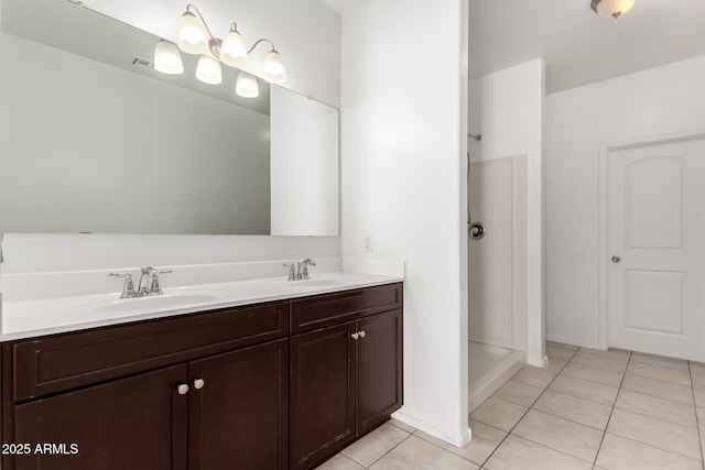 full bathroom featuring a stall shower, tile patterned flooring, a sink, and double vanity