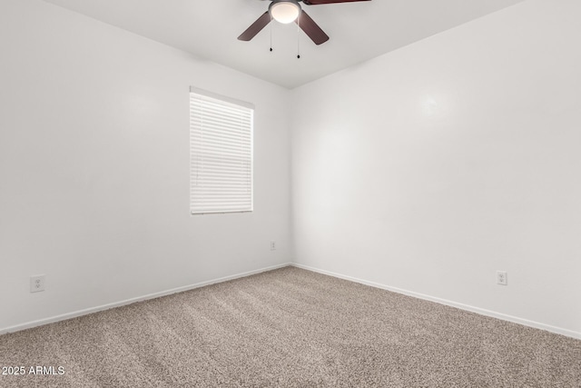 unfurnished room with carpet, a ceiling fan, and baseboards