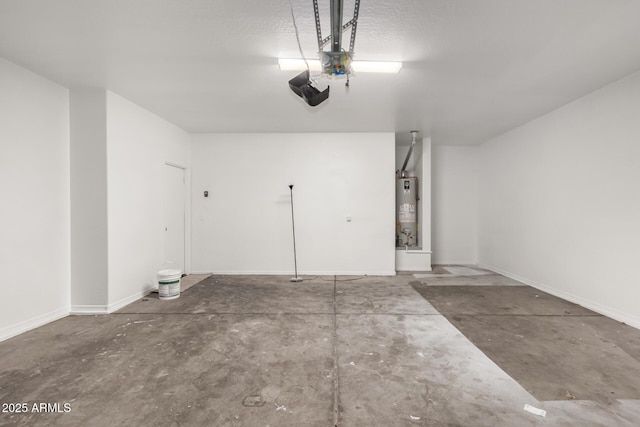 garage featuring a garage door opener, gas water heater, and baseboards