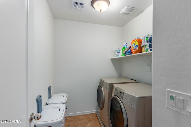 clothes washing area featuring washing machine and clothes dryer