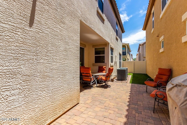 view of patio featuring central air condition unit and a grill