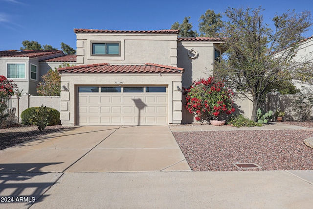 mediterranean / spanish home with a garage