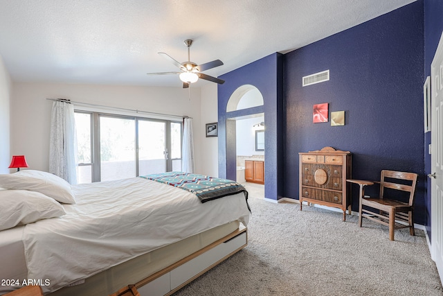 carpeted bedroom with access to exterior, a textured ceiling, vaulted ceiling, ceiling fan, and connected bathroom