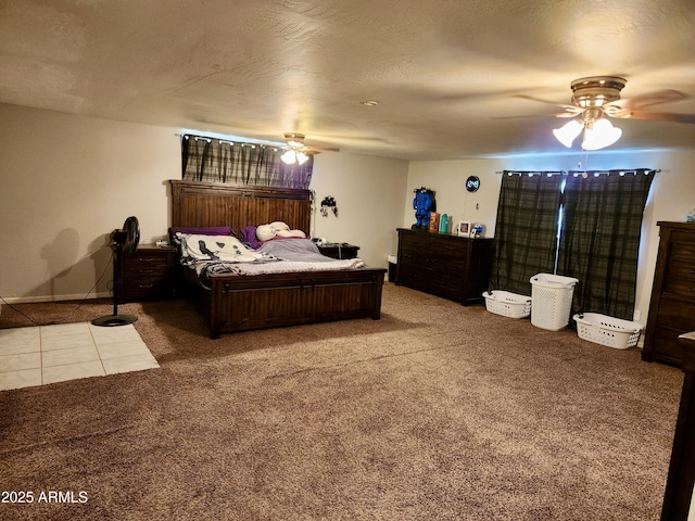 bedroom with tile patterned flooring, ceiling fan, a textured ceiling, and carpet