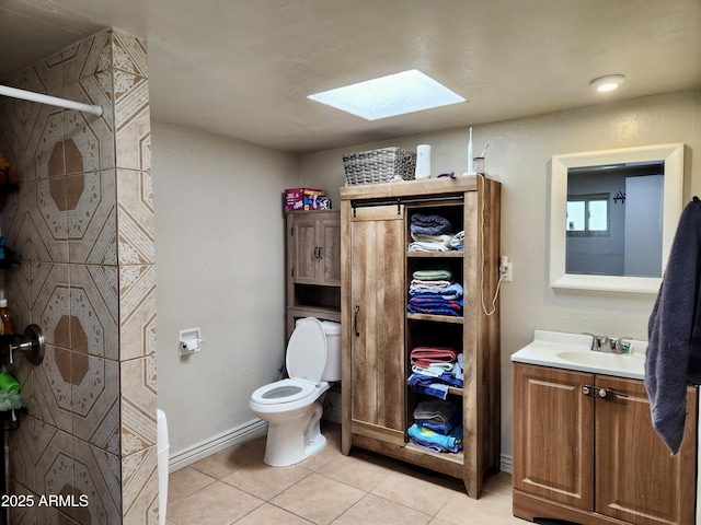 full bathroom with tile patterned flooring, toilet, a skylight, vanity, and a shower