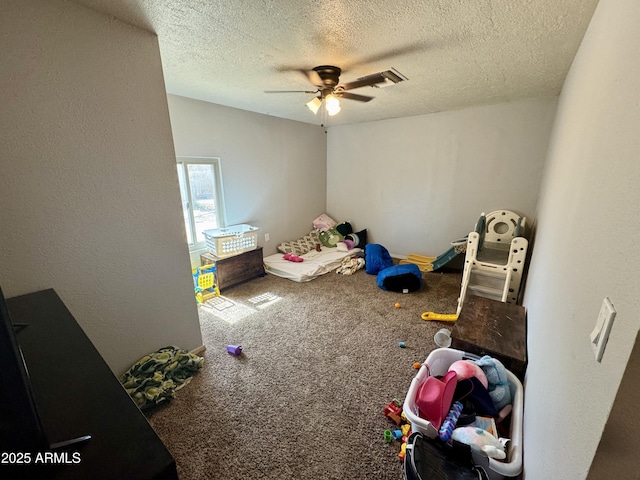 interior space with ceiling fan, carpet flooring, a textured wall, and a textured ceiling