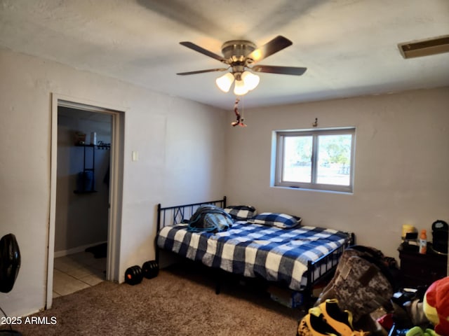 carpeted bedroom with tile patterned flooring, visible vents, and ceiling fan