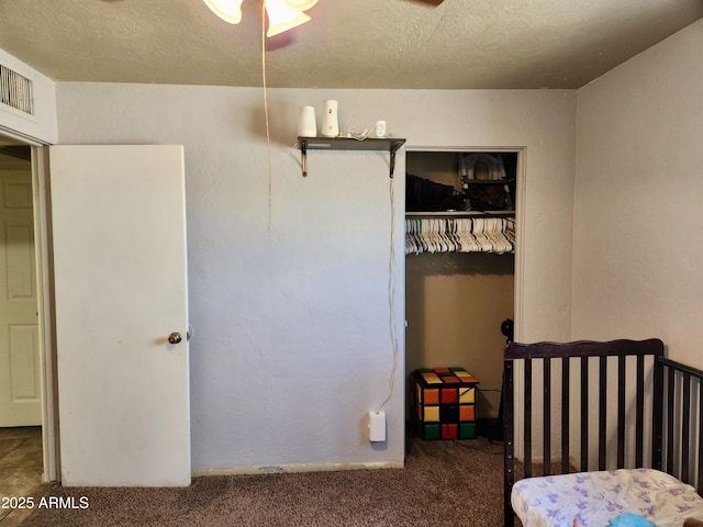 bedroom featuring carpet flooring, visible vents, a closet, and a textured ceiling