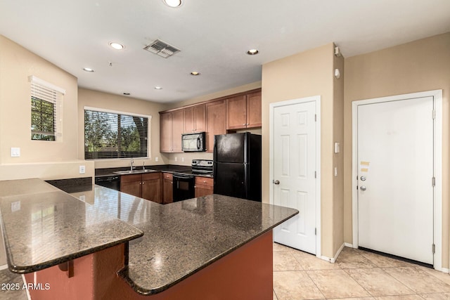 1250 S Rialto Unit 78, Mesa, AZ 85209 - kitchen featuring black appliances, a peninsula, dark stone counters, recessed lighting, and light tile patterned floors