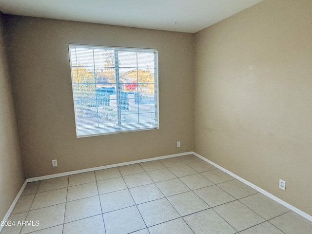 spare room with light tile patterned floors