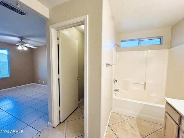 bathroom with ceiling fan, tile patterned flooring, shower / bath combination, a textured ceiling, and vanity