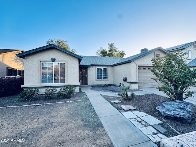 ranch-style house featuring a garage