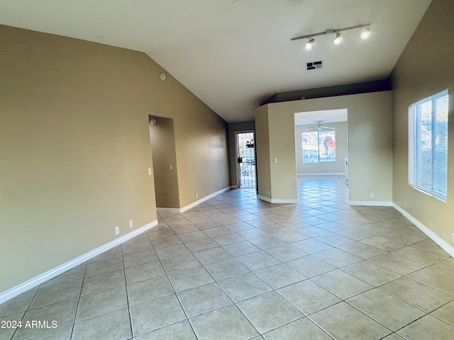 spare room with light tile patterned floors, ceiling fan, and lofted ceiling