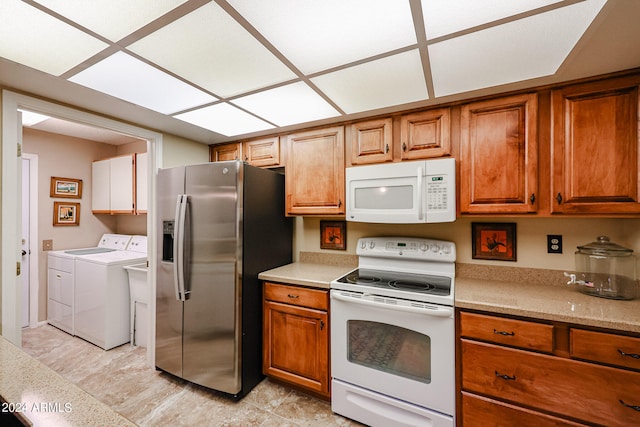 kitchen featuring separate washer and dryer and white appliances