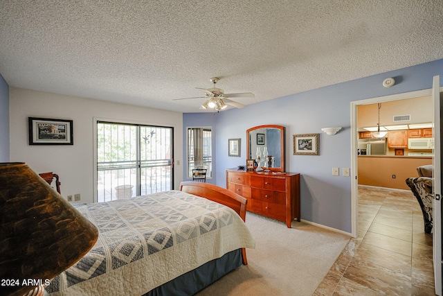 tiled bedroom with stainless steel refrigerator with ice dispenser, a textured ceiling, and ceiling fan