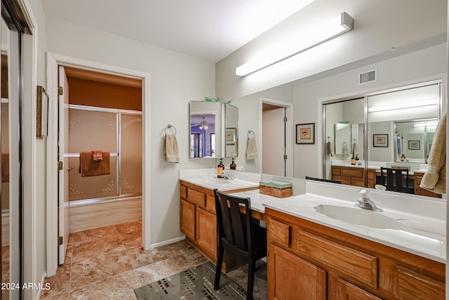 bathroom with walk in shower and vanity