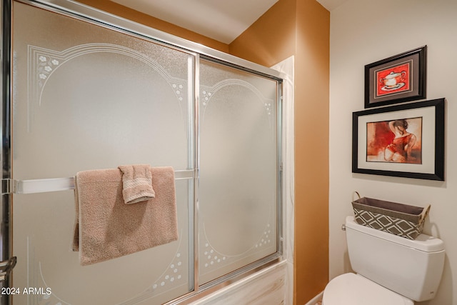 bathroom with an enclosed shower and toilet