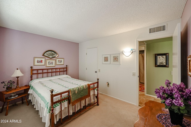 carpeted bedroom with a textured ceiling