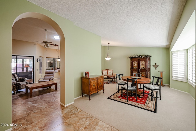 dining area with plenty of natural light, vaulted ceiling, carpet, and ceiling fan