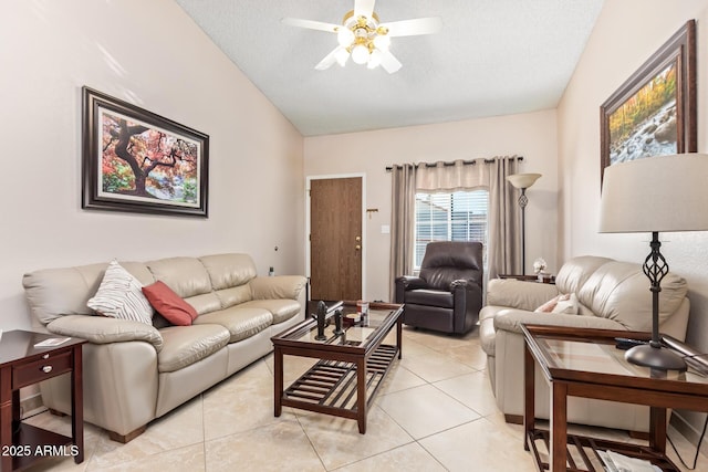 living room featuring ceiling fan, vaulted ceiling, a textured ceiling, and light tile patterned flooring