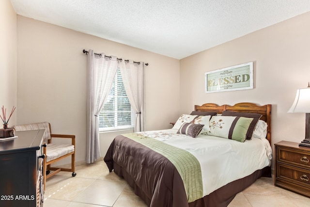 bedroom with light tile patterned floors and a textured ceiling