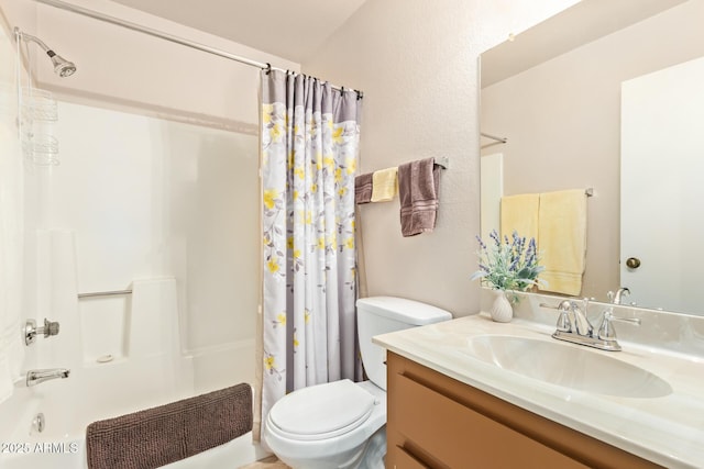 full bathroom with shower / bath combo, vanity, and toilet